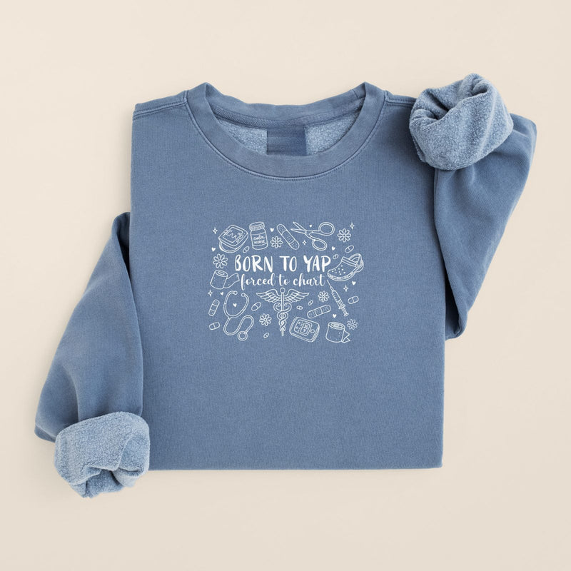 Born to Yap, Forced to Chart Sweatshirt in Blue Jean, folded flat on a warm oat background