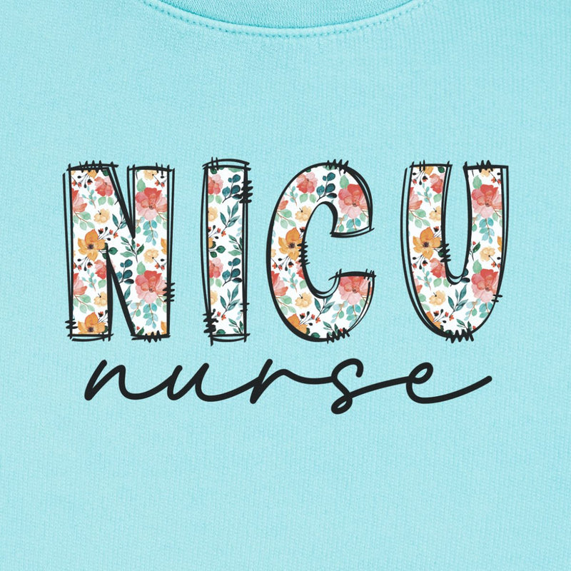 NICU Nurse Floral Sweatshirt in Chalky Mint, close-up of the floral "NICU" letters with black script "nurse" print on a folded crewneck