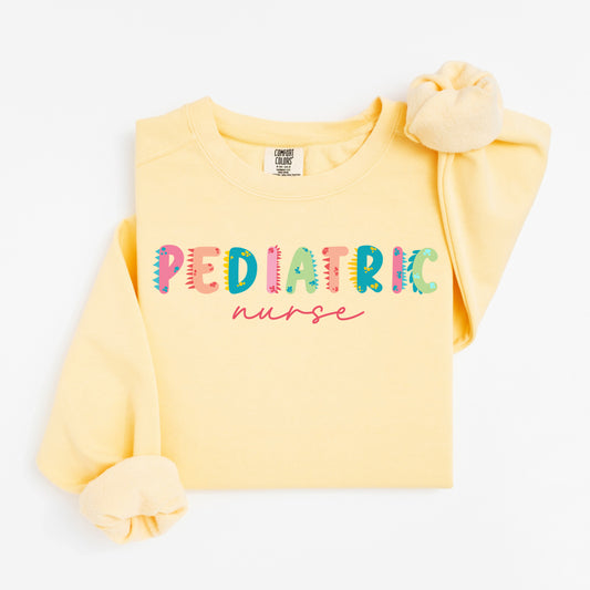 Cute Dino Pediatric Nurse Sweatshirt – Fun Dinosaur Lettering for Kid-Loving Nurses