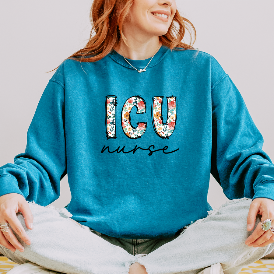 Model wearing the ICU nurse sweatshirt with floral block letters and script