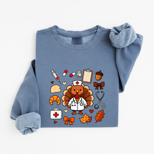 Blue Jean Cute Turkey Nurse Thanksgiving sweatshirt flat lay, turkey nurse in a white coat surrounded by nurse and fall icons, Comfort Colors 1466