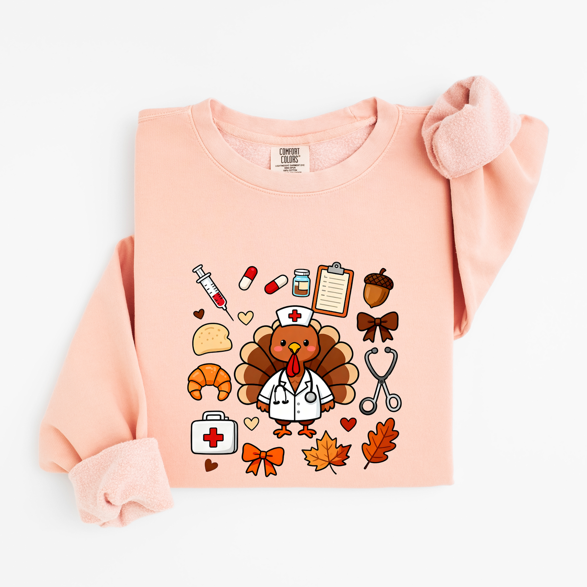Peachy Cute Turkey Nurse Thanksgiving sweatshirt flat lay, turkey nurse in a white coat surrounded by nurse and fall icons, Comfort Colors 1466