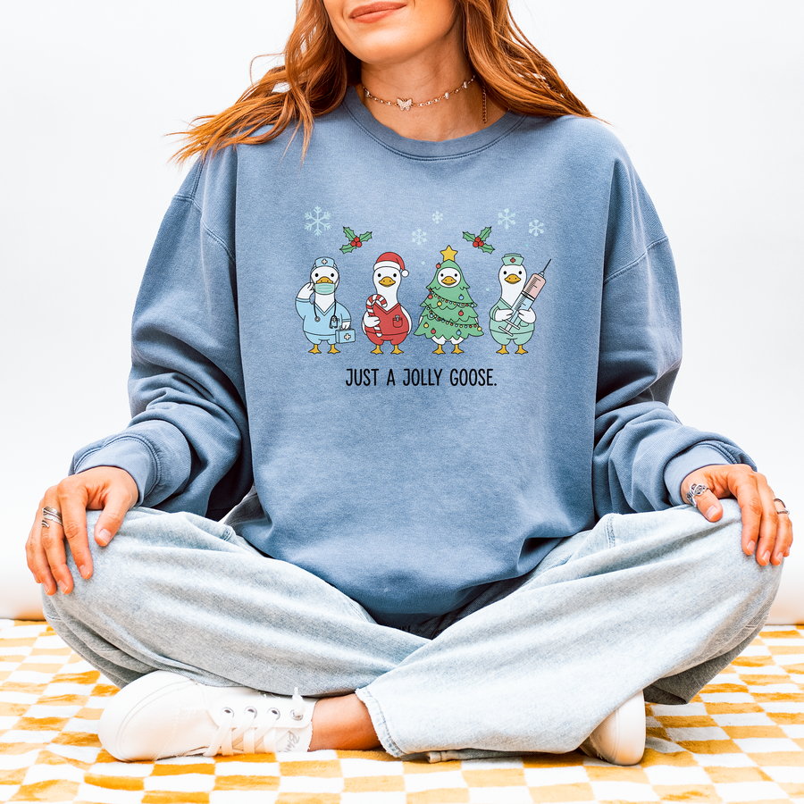 Model wearing the Just a Jolly Goose Christmas sweatshirt with festive nurse geese