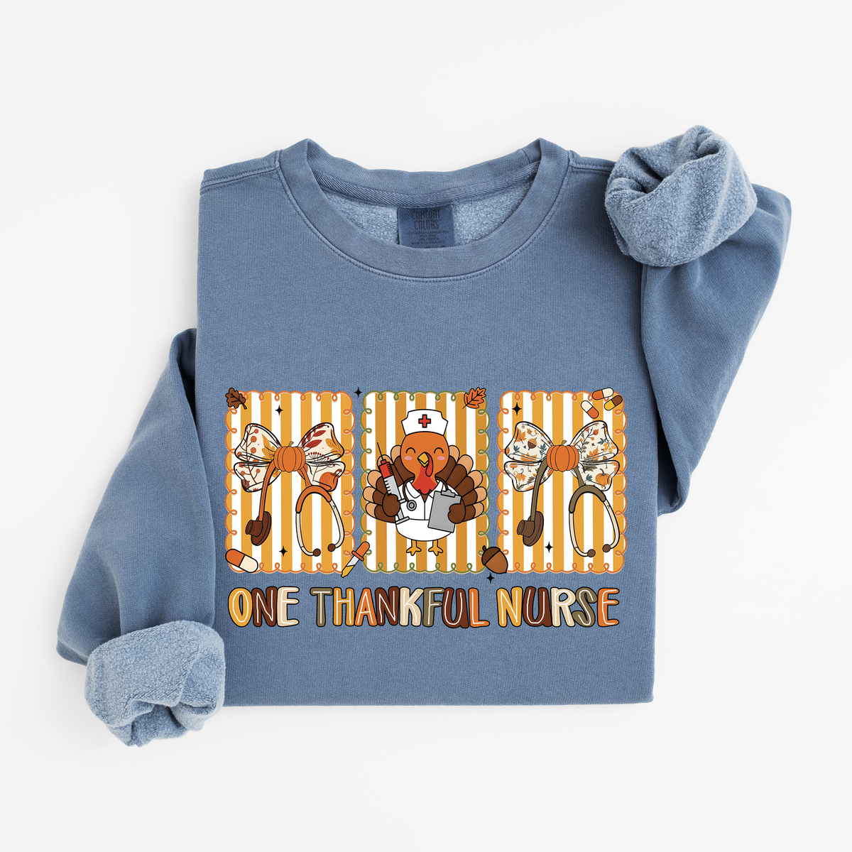 Blue Jean One Thankful Nurse Thanksgiving sweatshirt flat lay, One Thankful Nurse lettering with turkey nurse, fall bows and stethoscopes, Comfort Colors 1466