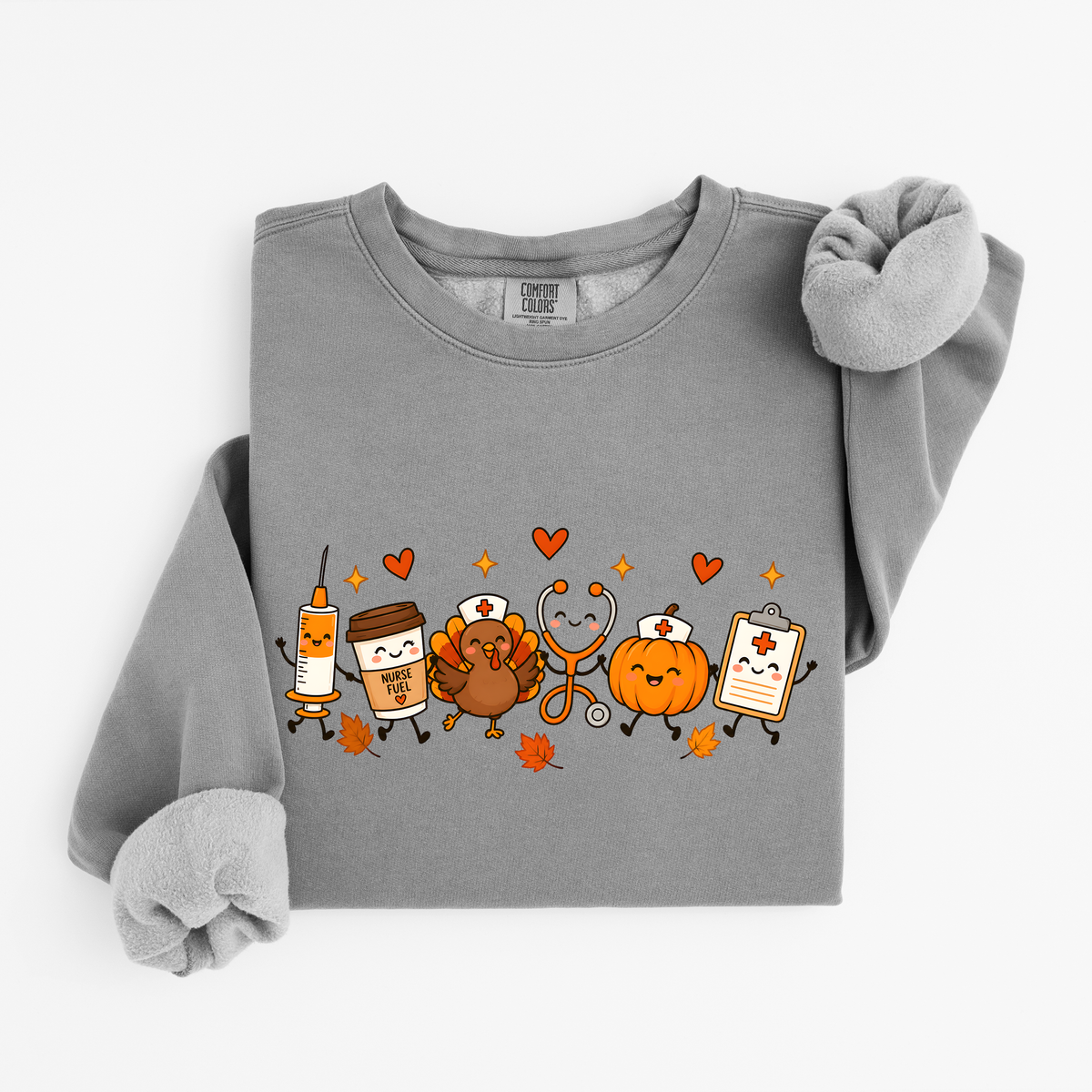 Grey Thanksgiving Nurse Friends sweatshirt flat lay, turkey, pumpkin, Nurse Fuel coffee, syringe, stethoscope and clipboard characters, Comfort Colors 1466