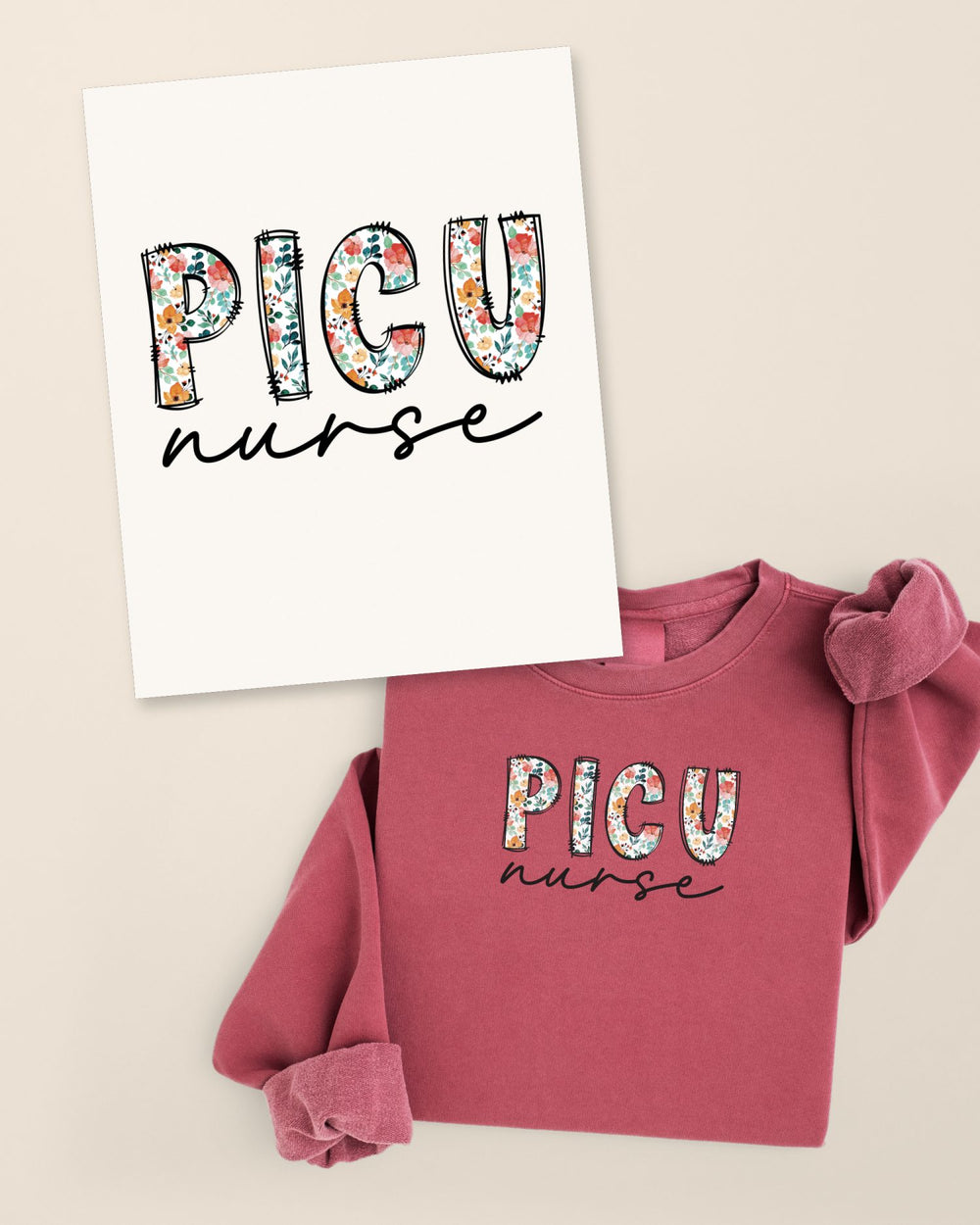 Folded Crimson Floral PICU crewneck beside a paper art card