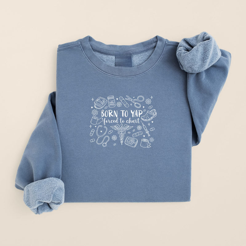 Born to Yap, Forced to Chart Sweatshirt in Blue Jean, folded flat on a warm oat background