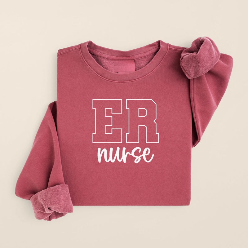 ER Nurse Varsity Crewneck in Crimson, folded flat on a warm oat background